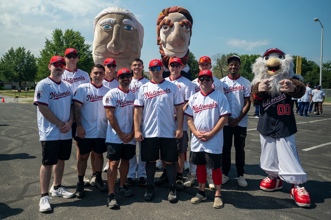 Team Joint Base Anacostia-Bolling poses with Washington Nationals mascots during the 2026 Battle of the Bases Military Softball Tournament at JBAB