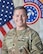 Male Soldier in front of American and Army Recruiting Flags