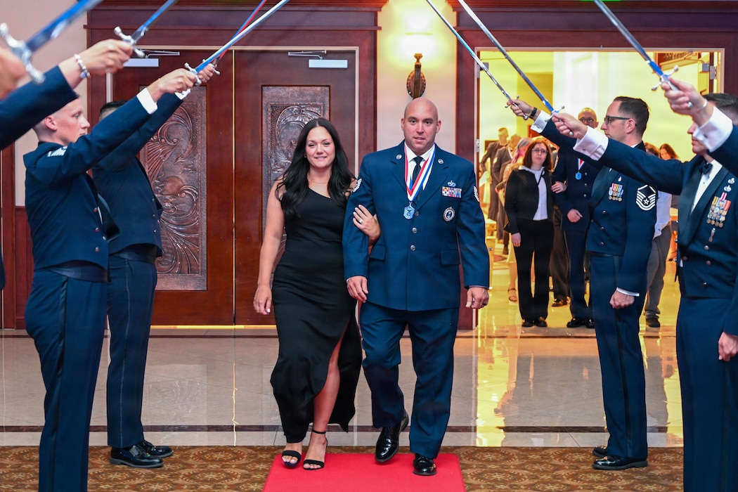 Airman walking under sword arch
