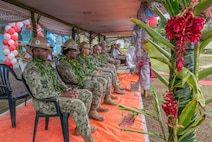 U.S. Navy Sailors assigned to Commander, Logistics Group Western Pacific/Task Force 73, and U.S. Navy Seabees assigned to Naval Mobile Construction Battalion (NMCB) 1 observe the festivities of the official ribbon cutting ceremony for the Pacific Partnership 2026 Nabua Village schoolhouse building project in Savusavu, Fiji, Jul. 27, 2026.