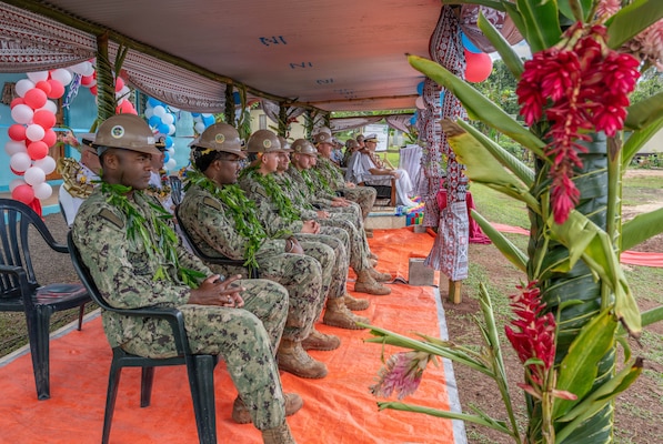 U.S. Navy Sailors assigned to Commander, Logistics Group Western Pacific/Task Force 73, and U.S. Navy Seabees assigned to Naval Mobile Construction Battalion (NMCB) 1 observe the festivities of the official ribbon cutting ceremony for the Pacific Partnership 2026 Nabua Village schoolhouse building project in Savusavu, Fiji, Jul. 27, 2026.