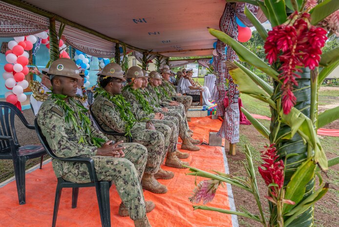 U.S. Navy Sailors assigned to Commander, Logistics Group Western Pacific/Task Force 73, and U.S. Navy Seabees assigned to Naval Mobile Construction Battalion (NMCB) 1 observe the festivities of the official ribbon cutting ceremony for the Pacific Partnership 2026 Nabua Village schoolhouse building project in Savusavu, Fiji, Jul. 27, 2026.