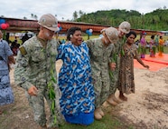 A group of Nabua villagers invite U.S. Navy Sailors assigned to Navy Mobile Construction Battalion (NMCB) 1 to take part in a traditional Fijian Meke dance after the official opening of the Pacific Partnership 2026 Nabua Village schoolhouse building in Savusavu, Fiji, Jul. 27, 2026.