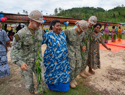 A group of Nabua villagers invite U.S. Navy Sailors assigned to Navy Mobile Construction Battalion (NMCB) 1 to take part in a traditional Fijian Meke dance after the official opening of the Pacific Partnership 2026 Nabua Village schoolhouse building in Savusavu, Fiji, Jul. 27, 2026.