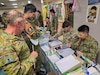 U.S. Army, Japan Ground Self-Defense Force and Australian Army personnel participate in a Japanese calligraphy activity at Camp Higashi-Chitose, Japan, Aug. 2026, ahead of Exercise Yama Sakura 91. Cultural exchanges before the exercise provide opportunities for participants to strengthen partnerships and build the personal relationships that support interoperability among the three nations. (U.S. Army photo by Lt. Col Jo Nederhoed)