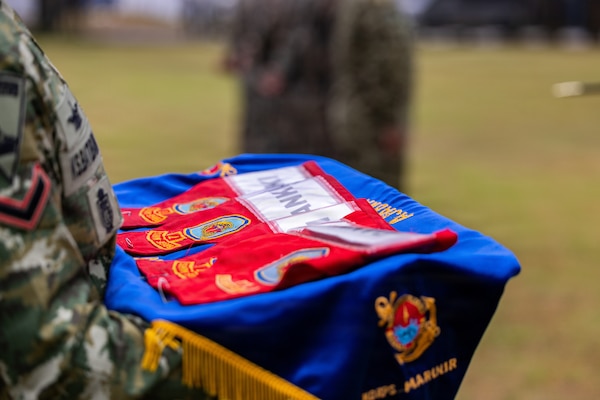 Ceremonial brassards for unit leaders with U.S. Marine Corps Alpha Company, 1st Battalion, 5th Marine Regiment, Marine Rotational Force – Darwin 26, Indonesian Marine Corps 7th Infantry Battalion, 4th Infantry Brigade, Republic of Korea Marine Corps 3rd Reconnaissance Battalion, 6th Marine Brigade, and Japan Ground Self-Defense Force 2nd Amphibious Rapid Deployment Regiment, Amphibious Rapid Deployment Brigade, are displayed during an opening ceremony for Exercise Super Garuda Shield  26 at the Indonesian Marine Corps 7th Infantry Battalion base near Lampung, Indonesia, Aug. 31, 2026.