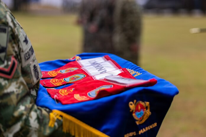 Ceremonial brassards for unit leaders with U.S. Marine Corps Alpha Company, 1st Battalion, 5th Marine Regiment, Marine Rotational Force – Darwin 26, Indonesian Marine Corps 7th Infantry Battalion, 4th Infantry Brigade, Republic of Korea Marine Corps 3rd Reconnaissance Battalion, 6th Marine Brigade, and Japan Ground Self-Defense Force 2nd Amphibious Rapid Deployment Regiment, Amphibious Rapid Deployment Brigade, are displayed during an opening ceremony for Exercise Super Garuda Shield  26 at the Indonesian Marine Corps 7th Infantry Battalion base near Lampung, Indonesia, Aug. 31, 2026.