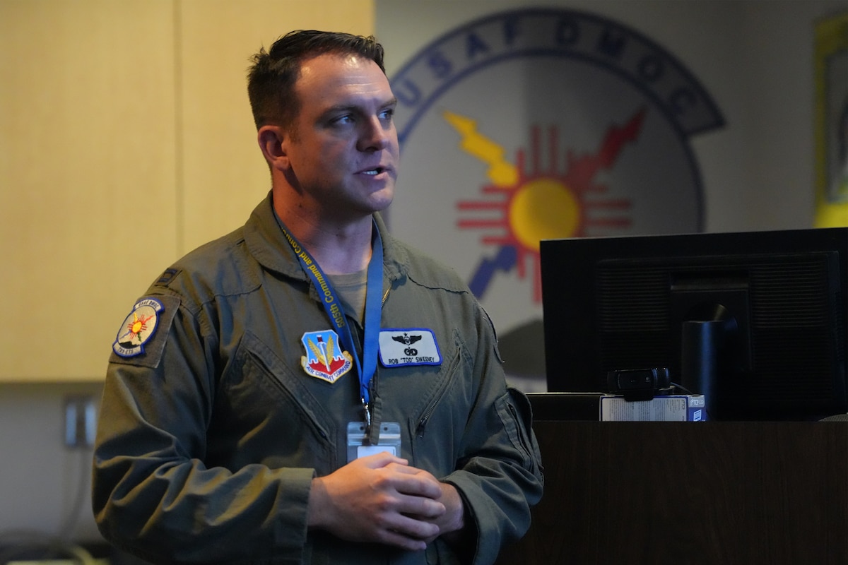 uniformed USAF member briefs other Airmen