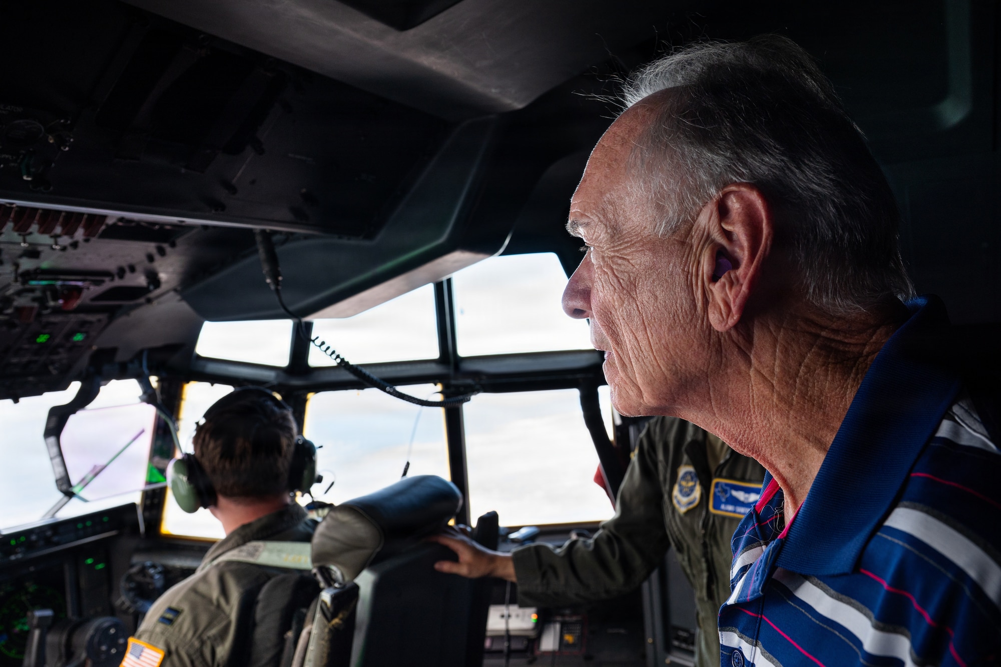 Sam Nichols, Air Mobility Command civic leader representing Dyess Air Force Base, Texas, observes in-flight operations from the flight deck of a U.S. Air Force C-130J Super Hercules enroute to McConnell Air Force Base, Kansas, Aug. 25, 2026. Nichols was among 23 AMC civic leaders who visited the 317th Airlift Wing as part of a multi-base tour designed to increase their understanding of AMC missions and capabilities. (U.S. Air Force photo by Senior Airman Jade M. Caldwell)