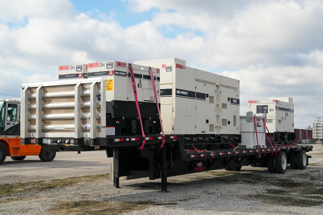 Generators and external fuel tanks sit on a flatbed