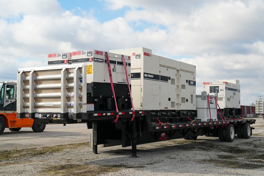 Generators and external fuel tanks sit on a flatbed