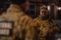 Chief Warrant Officer 5 Robert W. Gibson Sr., command chief warrant officer of the District of Columbia National Guard, observes Soldiers during a nighttime presence patrol in Washington, D.C., Jan. 30, 2026, in support of the D.C. Safe and Beautiful mission. Senior leaders conducted ground-level engagement to assess operations and ensure effective coordination with local and federal partners. (U.S. Air National Guard photo by Master Sgt. William Blankenship)