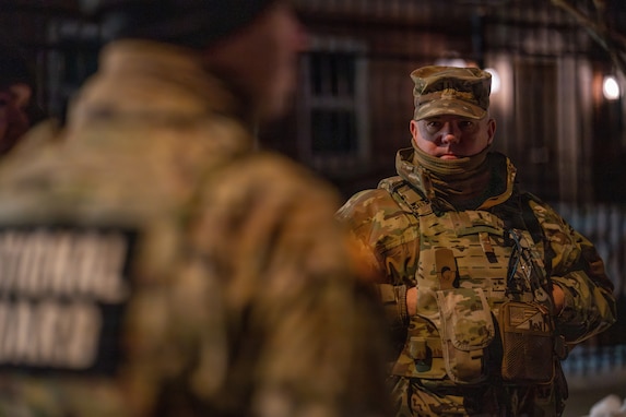 Chief Warrant Officer 5 Robert W. Gibson Sr., command chief warrant officer of the District of Columbia National Guard, observes Soldiers during a nighttime presence patrol in Washington, D.C., Jan. 30, 2026, in support of the D.C. Safe and Beautiful mission. Senior leaders conducted ground-level engagement to assess operations and ensure effective coordination with local and federal partners. (U.S. Air National Guard photo by Master Sgt. William Blankenship)