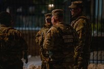 U.S. Army Col. Larry Doane, commander of Joint Task Force–D.C., speaks with Soldiers during a nighttime presence patrol in Washington, D.C., Jan. 30, 2026, in support of the D.C. Safe and Beautiful mission. Doane conducted on-the-ground assessments to evaluate mission execution and reinforce command presence across assigned sectors. (U.S. Air National Guard photo by Master Sgt. William Blankenship)