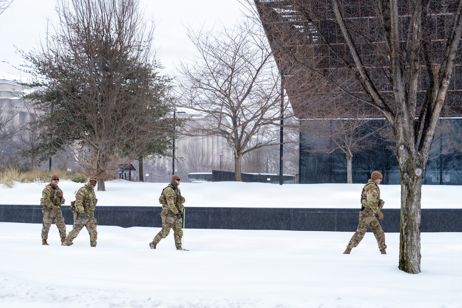 Service members assigned to the National Guard move throughout Washington, D.C. to assist residents during a winter storm, Jan. 25, 2026, in support of the D.C. Safe and Beautiful mission. Snow and icy conditions impacted travel across the District, prompting National Guard personnel to provide assistance to people in need while maintaining a visible presence in affected neighborhoods. As part of the D.C. Safe and Beautiful mission, approximately 2,500 National Guard members support local and federal partners to help maintain public safety and community resilience throughout the nation’s capital. (U.S. Air National Guard photo by Master Sgt. William Blankenship)