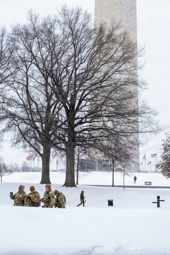 Service members assigned to the National Guard move throughout Washington, D.C. to assist residents during a winter storm, Jan. 25, 2026, in support of the D.C. Safe and Beautiful mission. Snow and icy conditions impacted travel across the District, prompting National Guard personnel to provide assistance to people in need while maintaining a visible presence in affected neighborhoods. As part of the D.C. Safe and Beautiful mission, approximately 2,500 National Guard members support local and federal partners to help maintain public safety and community resilience throughout the nation’s capital. (U.S. Air National Guard photo by Master Sgt. William Blankenship)