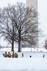 Service members assigned to the National Guard move throughout Washington, D.C. to assist residents during a winter storm, Jan. 25, 2026, in support of the D.C. Safe and Beautiful mission. Snow and icy conditions impacted travel across the District, prompting National Guard personnel to provide assistance to people in need while maintaining a visible presence in affected neighborhoods. As part of the D.C. Safe and Beautiful mission, approximately 2,500 National Guard members support local and federal partners to help maintain public safety and community resilience throughout the nation’s capital. (U.S. Air National Guard photo by Master Sgt. William Blankenship)
