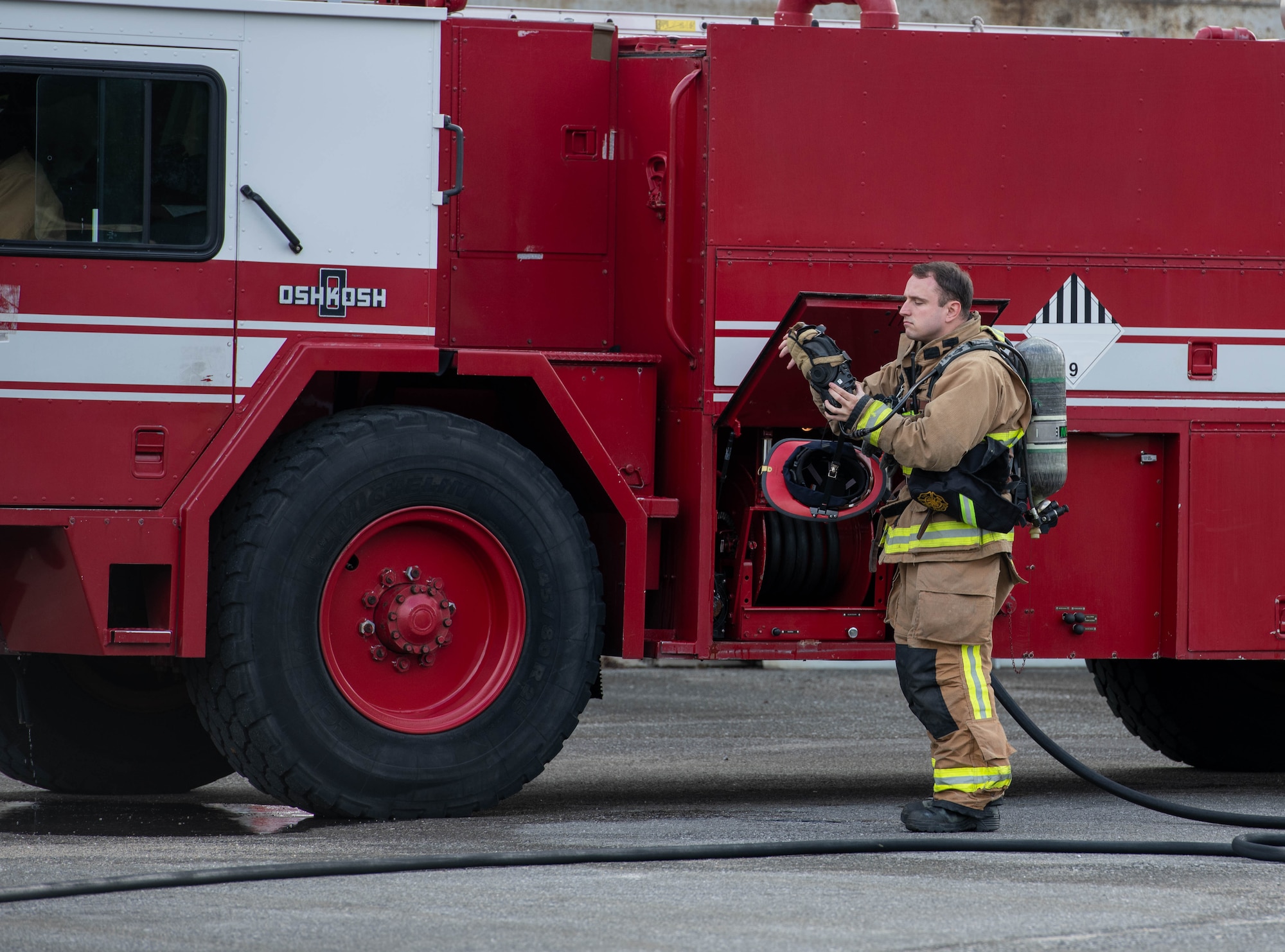 Service member putting on gear.