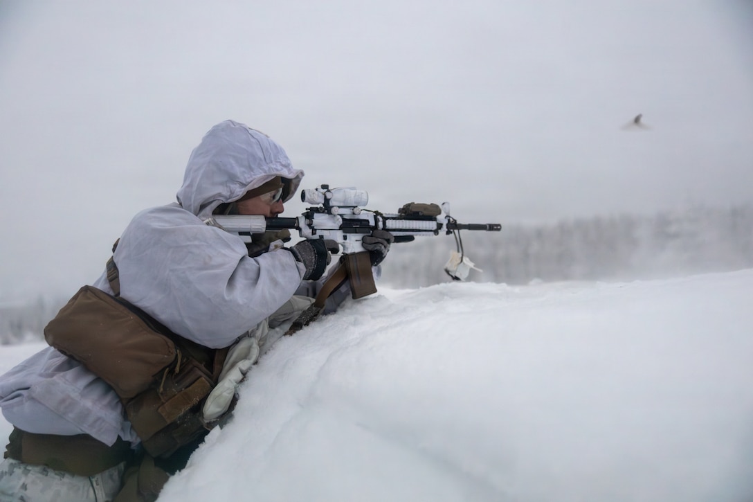 U.S. Marine Corps Gunnery Sgt. Joshua Wheeler, radio reconnaissance platoon sergeant with 2d Radio Battalion, 2nd Marine Expeditionary Force, fires an M4 carbine while conducting ambush training in Kalix, Sweden, Jan. 13, 2026. The purpose of Winter Warfare Course is to train ground forces in a variety of cold-weather subjects, including skiing, how to use pulk sleds, develop winter fighting positions, camouflage and concealment, and several other areas that are vital in order to survive and operate in a cold-weather environment. It was also conducted in preparation for exercise Cold Response 26. (U.S. Marine Corps photo by Lance Cpl. Hunter J. Kuester)