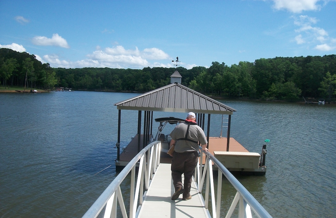 A park ranger at Kerr Reservoir conducts an inspection of a private, permitted dock at Kerr Reservoir on a beautiful summer day.