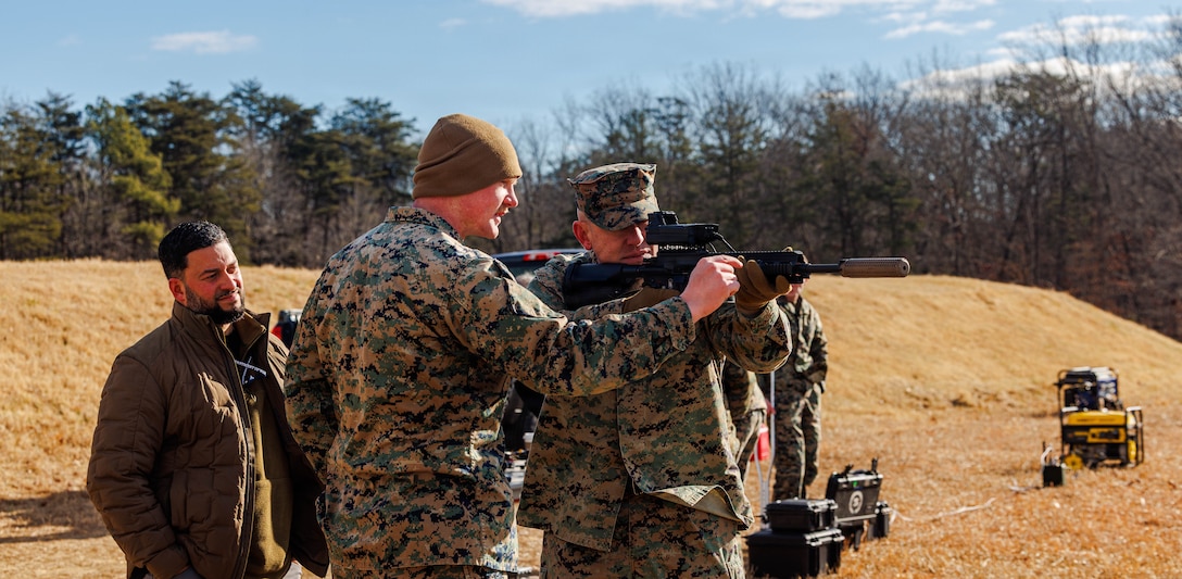 U.S. Marine Corps Cpl. Kyle L. Morgan, a military police officer with the Counter-Unmanned Aerial System’s Counter-Drone Team, explains equipment used for C-UAS to Col. Dennis W. Sampson, the Officer in Charge of Expeditionary Operations Training Group II Marine Expeditionary Force, during a C-UAS demo at The Basic School on Marine Corps Base Quantico, Virginia, Jan. 15, 2026. MCB Quantico’s Provost Marshal Office C-UAS Counter-Drone Team showcase tactics and technologies that counter aerial threats. (U.S. Marine Corps photo by Lance Cpl. Donovan E. Melendez)
