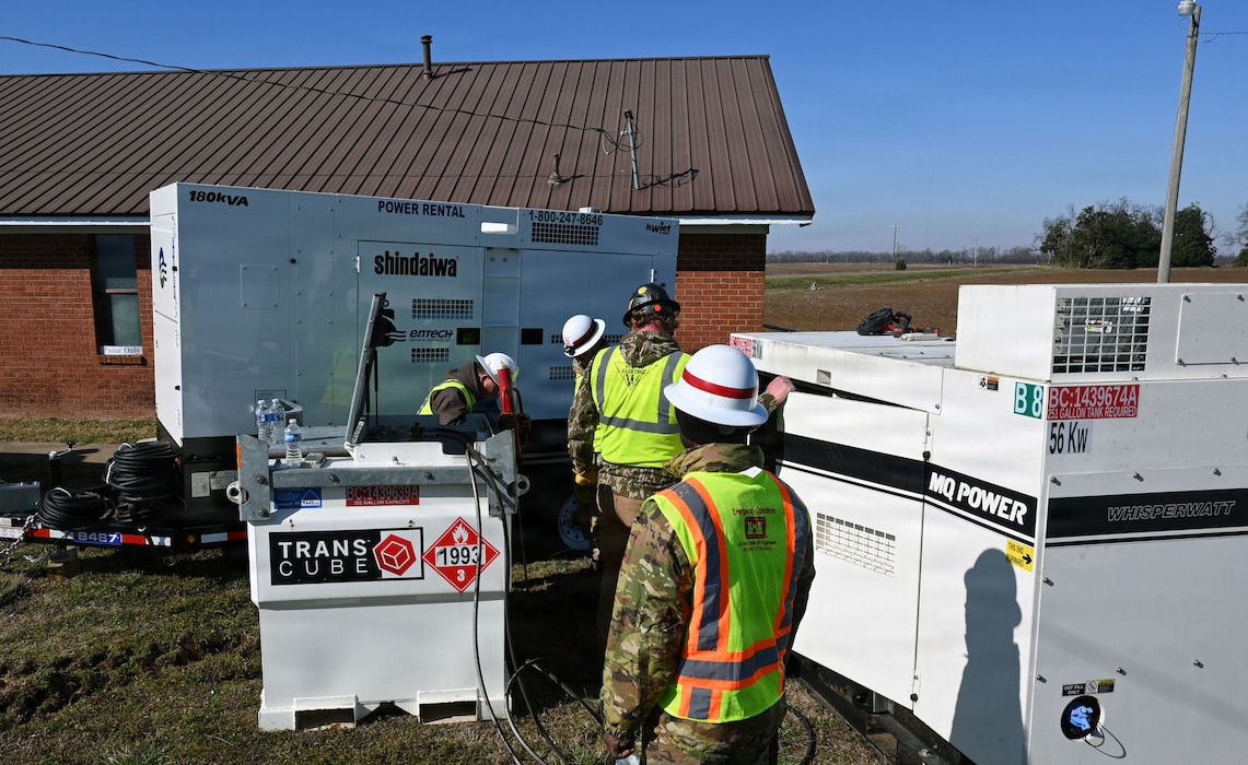 Soldiers are seen working on a generator