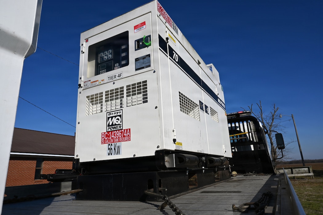 A generator sits on the back of a flatbed truck