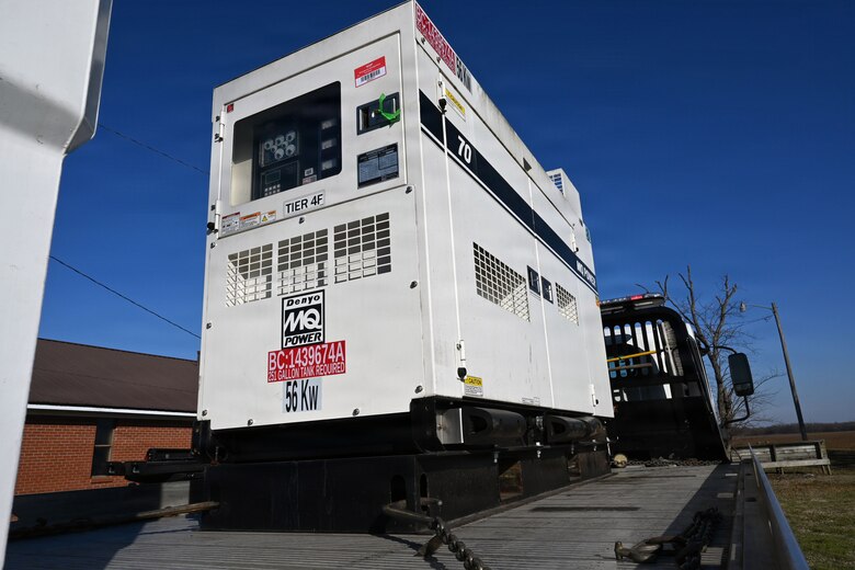 A generator sits on the back of a flatbed truck