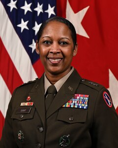 U.S. Army Maj. Gen. Antoinette Gant, Commanding General of Joint Task Force-National Capital Region and U.S. Army Military District of Washington, posing for an official portrait wearing Army green service uniform in front of the U.S. Flag and the red 2-star general flag.