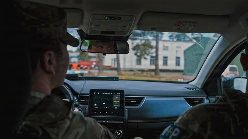 U.S. Army Pfc. Jack Hajewski, a military police Soldier with the 327th Military Police Battalion, 102nd Military Police Company, waits for a cargo vehicle to enter the camp to conduct a Random Antiterrorism Measure at Camp Adazi, Latvia, on Dec. 10, 2025. RAMs provide a visible security presence and help safeguard personnel, equipment, and facilities, supporting force protection efforts and contributing to overall readiness among U.S. and NATO allies. (U.S. Army photo by Sgt. James Garcia)