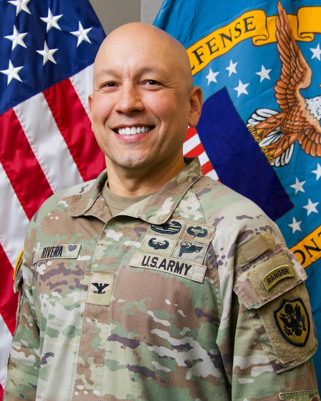 Army officer in front of US flag
