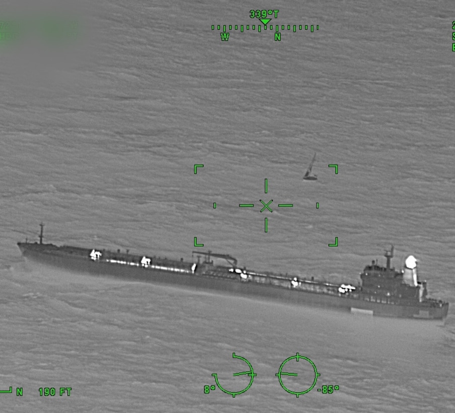 A Coast Guard Air Station Elizabeth City HC-130 Hercules aircrew works alongside motor tanker Radiant Pride's crew to rescue three mariners aboard a 44-foot sailing vessel taking on water, 450 miles east of Daytona Beach, Feb. 1, 2026. The three mariners were brought aboard Radiant Pride in stable condition with no injuries reported. (U.S. Coast Guard photo courtesy of Air Station Elizabeth City HC-130 aircrew)