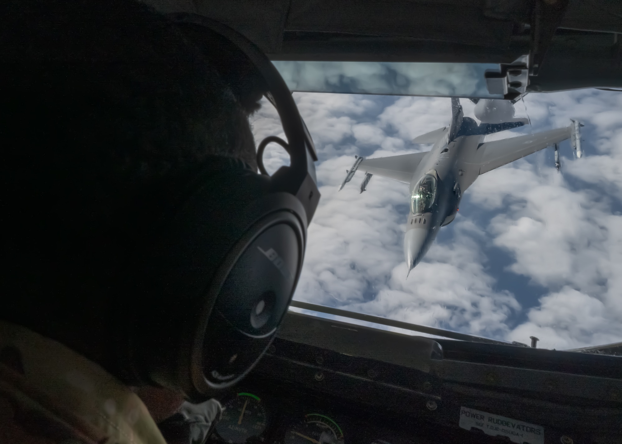 A U.S. Air Force F-16C Fighting Falcon assigned to the 120th Expeditionary Fighter Squadron, deployed to Kadena Air Base, conducts aerial refueling operations with a KC-135 Stratotanker from the 909th Air Refueling Squadron over the Pacific Ocean.