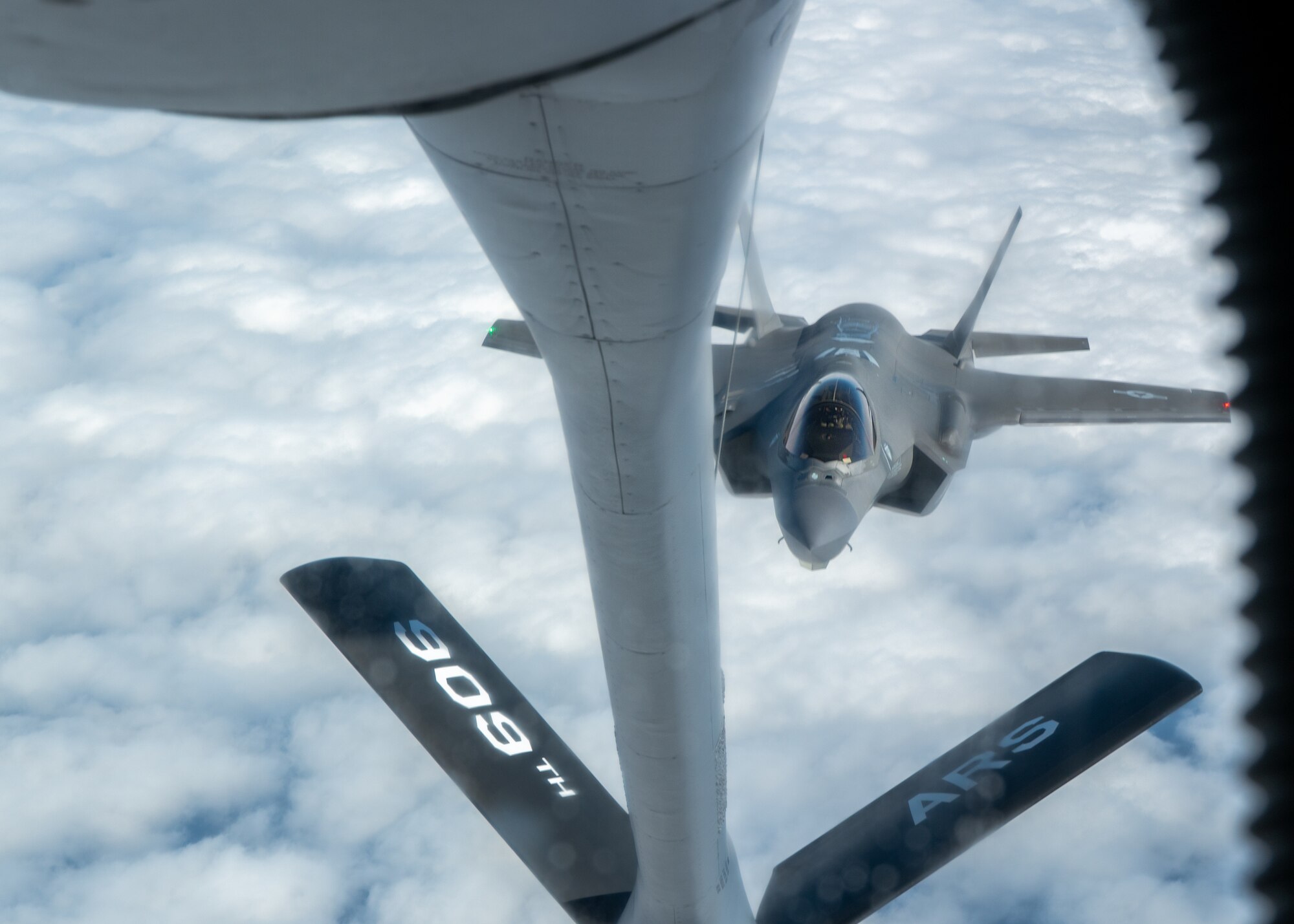 A U.S. Air Force F-35A Lightning II assigned to the 4th Expeditionary Fighter Squadron, deployed to Kadena Air Base, approaches a KC-135 Stratotanker assigned to the 909th Air Refueling Squadron over the Pacific Ocean.