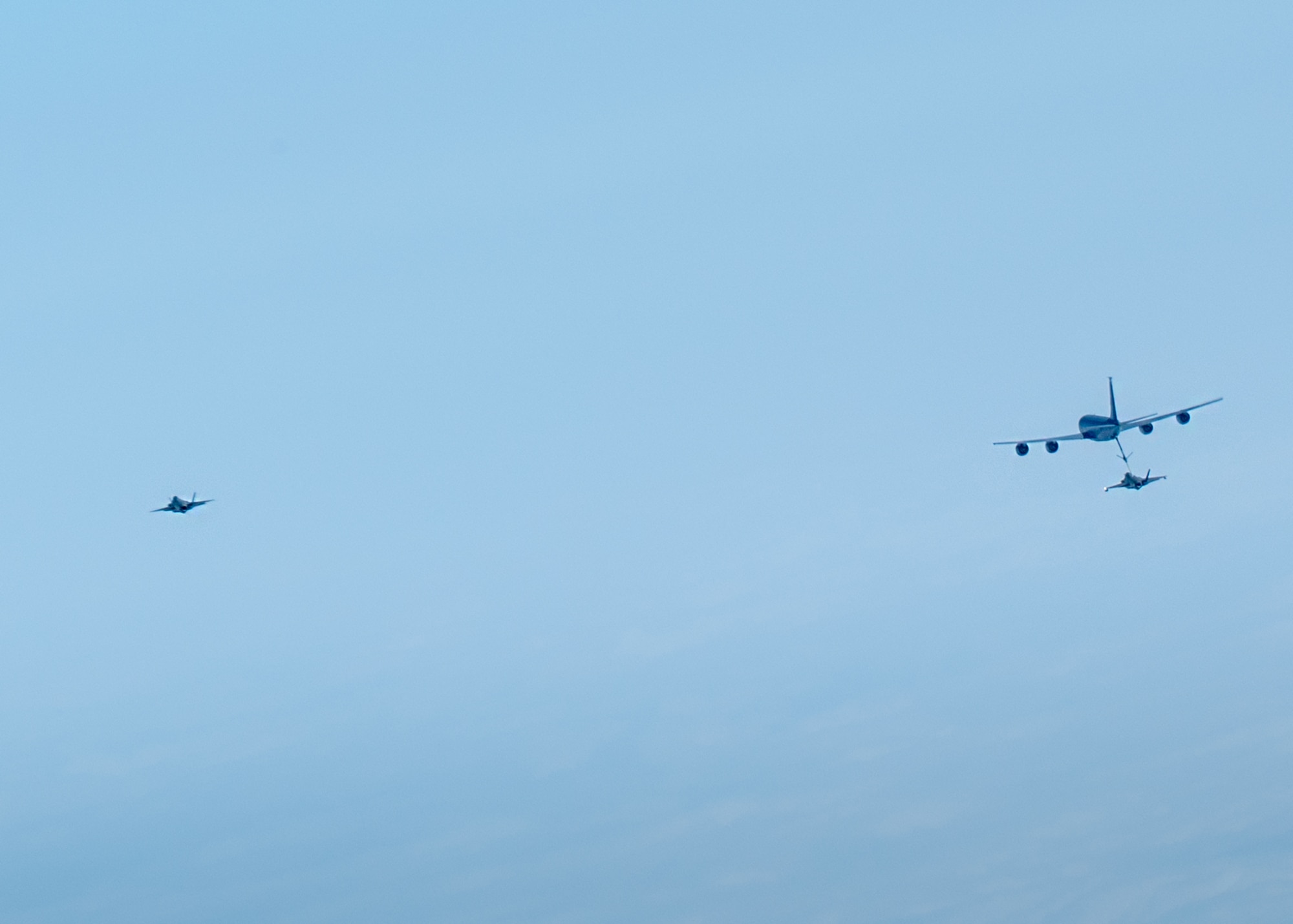 Two U.S. Air Force F-35A Lightning IIs assigned to the 4th Expeditionary Fighter Squadron, deployed to Kadena Air Base, conduct aerial refueling operations with a KC-135 Stratotanker assigned to the 909th Air Refueling Squadron over the Pacific Ocean.