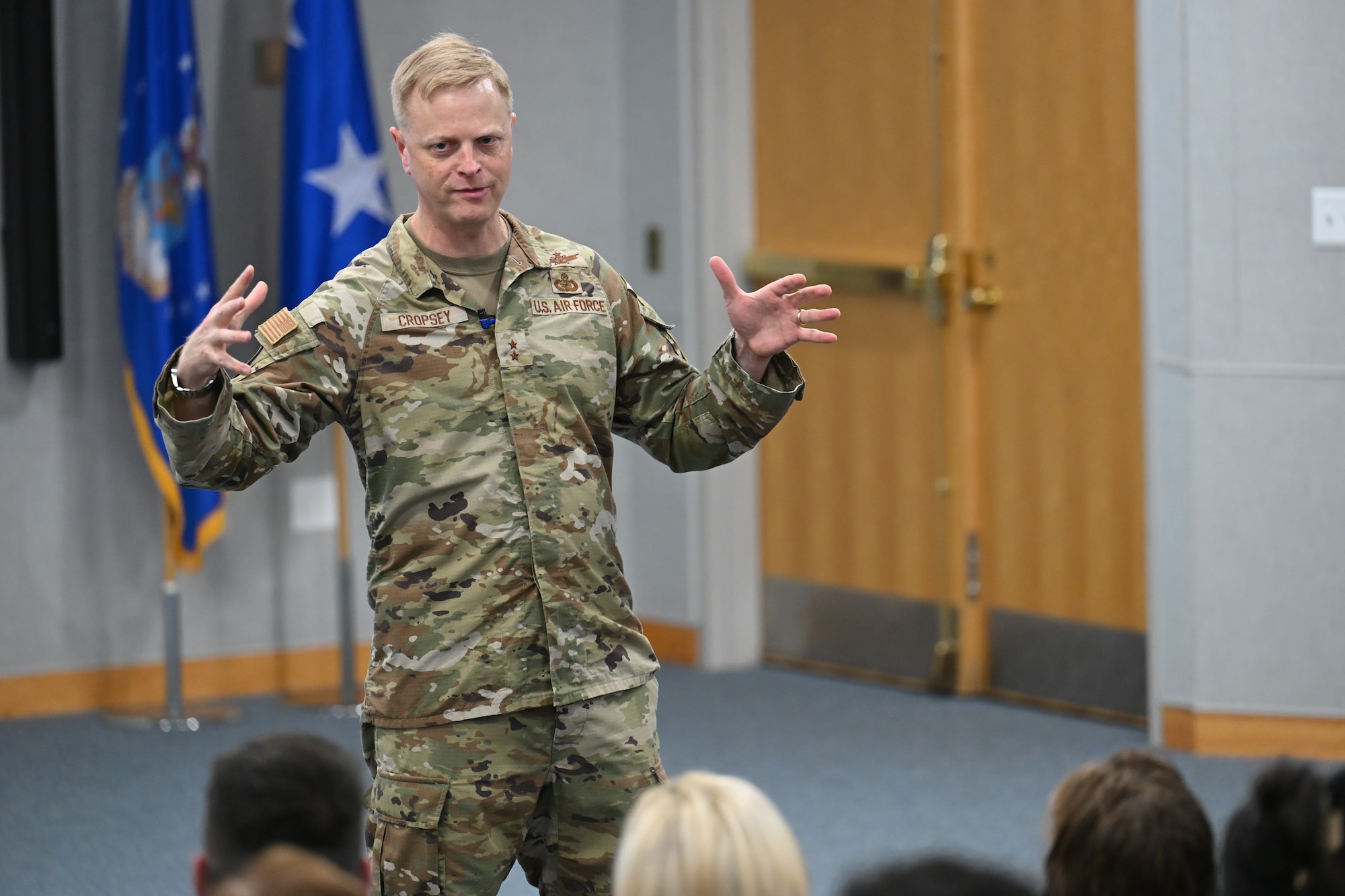 Then Maj. Gen. Luke Cropsey unveils strategic anchors during an All Call here, July 30, 2025. During Cropsey’s time in command, the Department of the Air Force Portfolio Acquisition Executive for Command, Control, Communications and Battle Management evolved both structurally and culturally, aligning its programs and people to better support the Air Force’s role in joint all-domain command and control. (Official Air Force Photo by Richard Blumenstein).