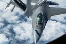 A U.S. Air Force F-16C Fighting Falcon assigned to the 120th Expeditionary Fighter Squadron, deployed to Kadena Air Base, approaches a KC-135 Stratotanker assigned to the 909th Air Refueling Squadron over the Pacific Ocean.