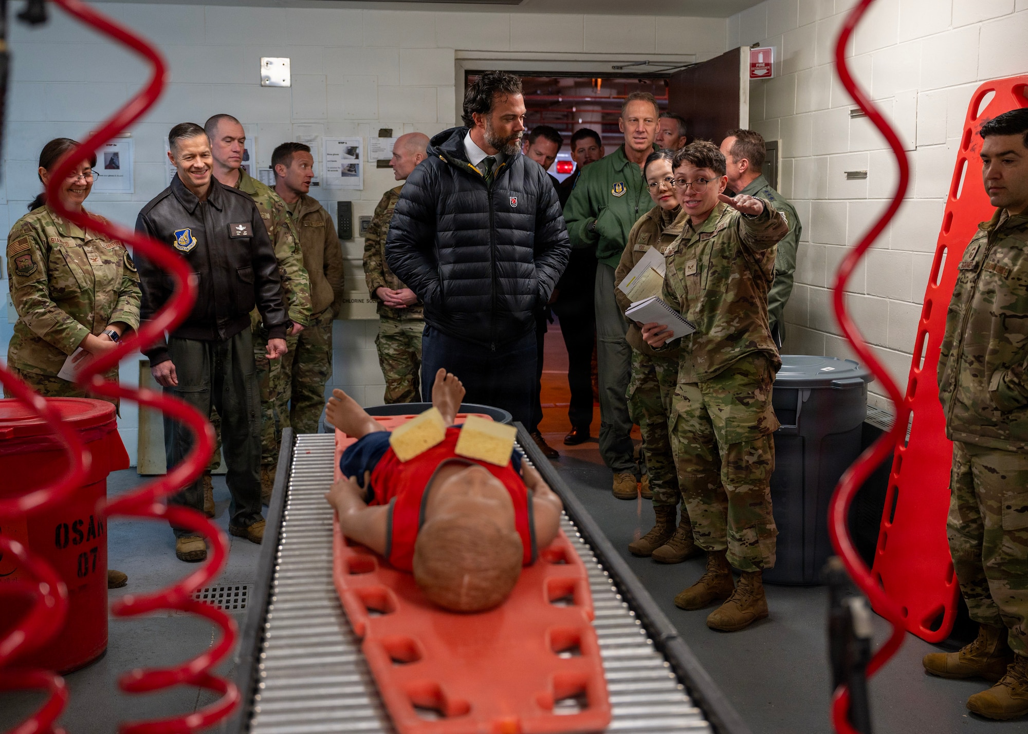 U.S. Air Force Senior Airman Dominick Jackson, 51st Medical Support Squadron unit deployment manager, briefs Under Secretary of the Air Force Matt Lohmeier on 51st Medical Group chemical, biological, radiological, nuclear decontamination procedures at Osan Air Base, Republic of Korea, Jan. 30, 2026. Lohmeier is visiting the Indo-Pacific to engage with Airmen, Guardians, allies, and partners and to see firsthand how Pacific Air Forces is postured to meet strategic challenges in the region. (U.S. Air Force photo by Staff Sgt. Sarah Williams)