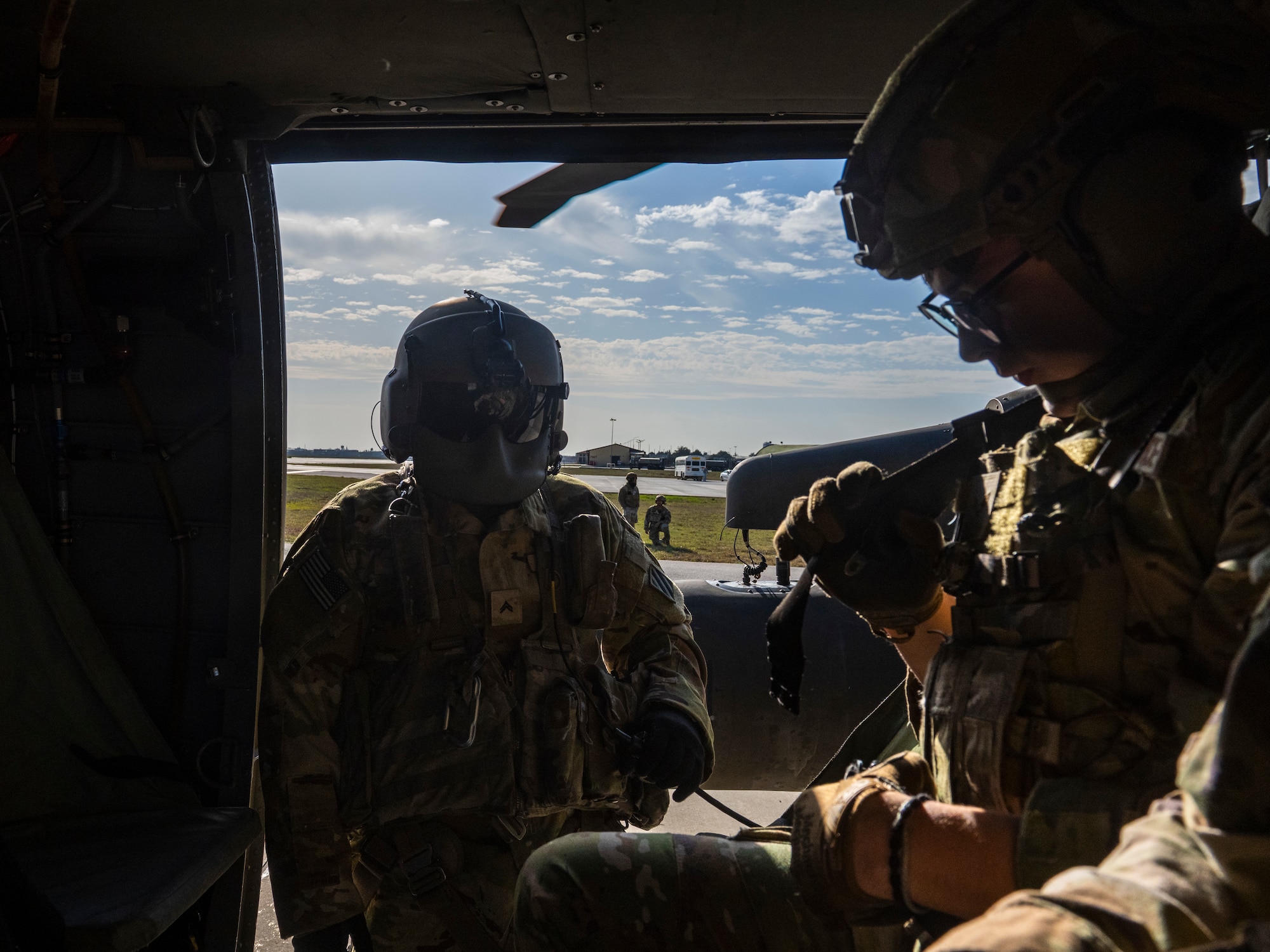 A U.S. Army Soldier conducts pre-flight safety checks aboard a UH-60 Black Hawk helicopter
