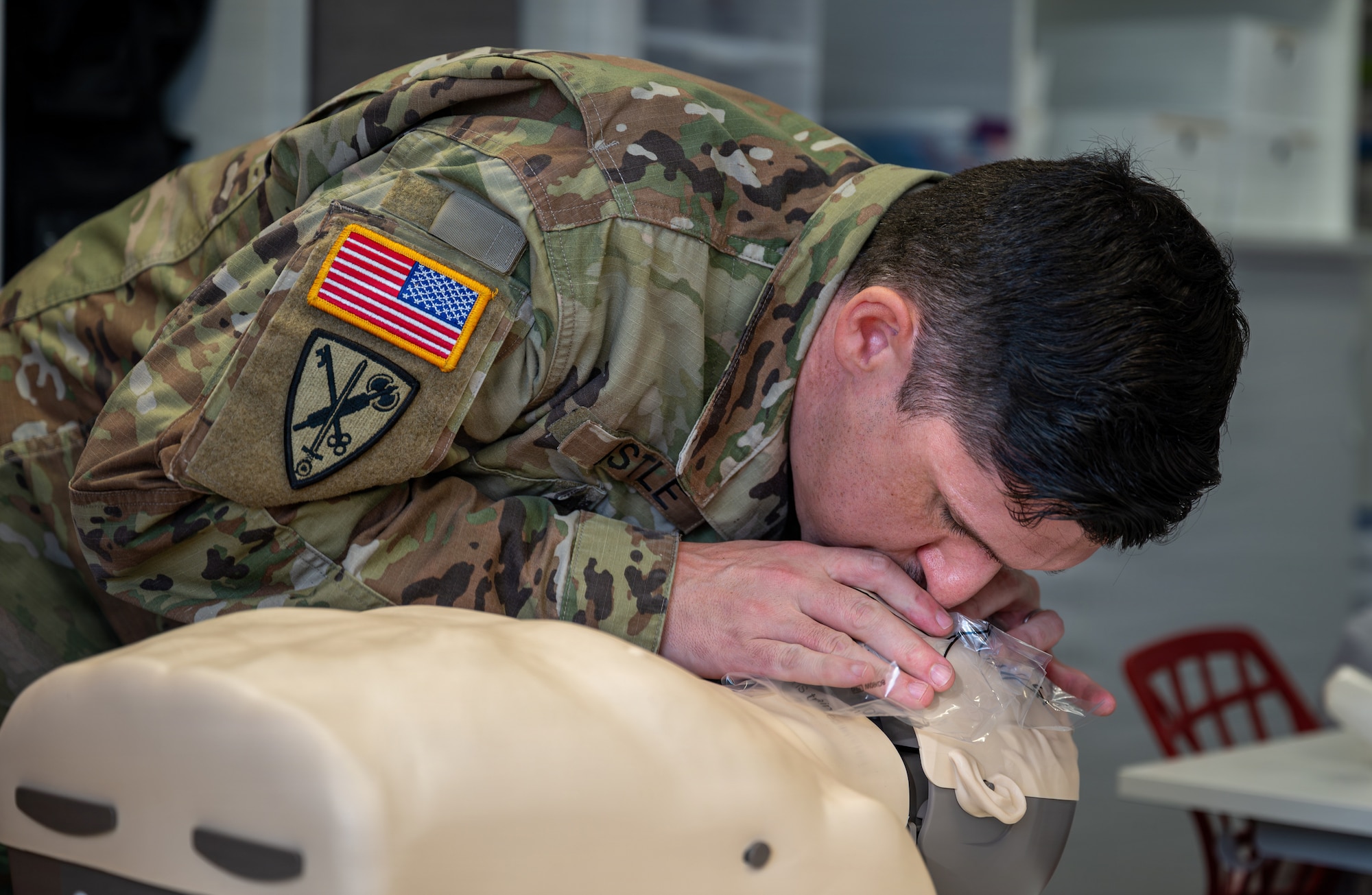 U.S. Army Staff Sgt. Colin Astle, Rhine Ordnance Barracks directorate of emergency services desk sergeant, gives breaths to a Braden BigRed life-saving mannequin during an American Red Cross Ramstein Office Adult and Pediatric First Aid/CPR/AED course at Ramstein Air Base, Germany, Jan. 22, 2026.