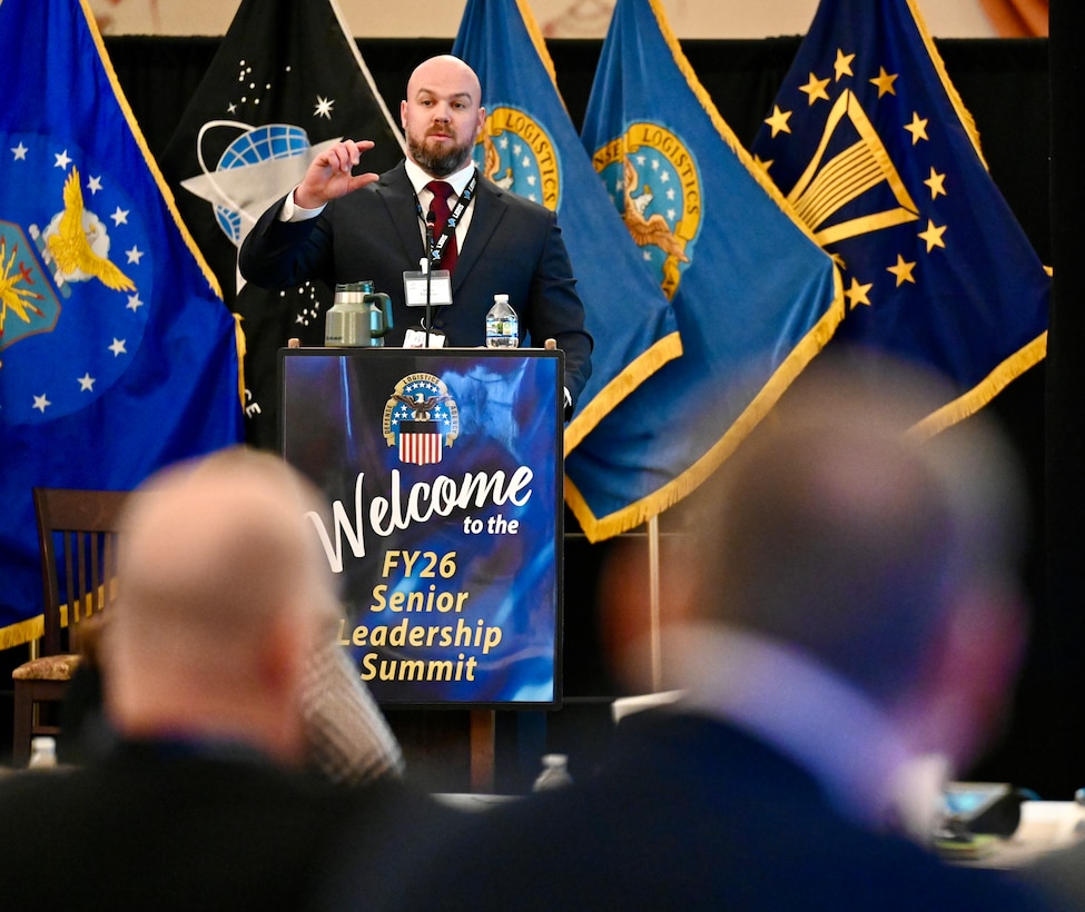 DLA Disposition Services Strategic Planning Specialist and Culture Action Team (CAT) Culture Champion Shon Thomas delivers a presentation from a podium