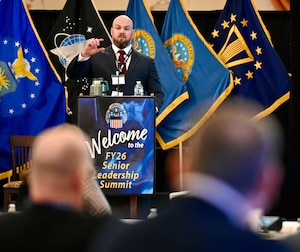 DLA Disposition Services Strategic Planning Specialist and Culture Action Team (CAT) Culture Champion Shon Thomas delivers a presentation from a podium