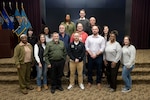 Group photo of 15 people inside conference room