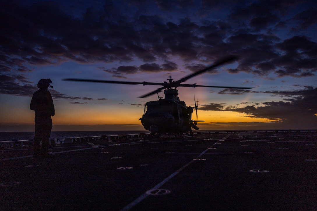 A U.S. Marine Corps UH-1Y Venom helicopter with Marine Medium Tiltrotor Squadron (VMM) 263 (Reinforced), 22nd Marine Expeditionary Unit (Special Operations Capable), prepares to take off during a night aerial sniper live-fire aboard San Antonio-class amphibious transport dock ship USS Fort Lauderdale (LPD 28) while underway in the Caribbean Sea, Jan. 26, 2026. U.S. military forces are deployed to the Caribbean in support of the U.S. Southern Command mission, Department of War-directed operations, and the president's priorities to disrupt illicit drug trafficking and protect the homeland. (U.S. Marine Corps photo)