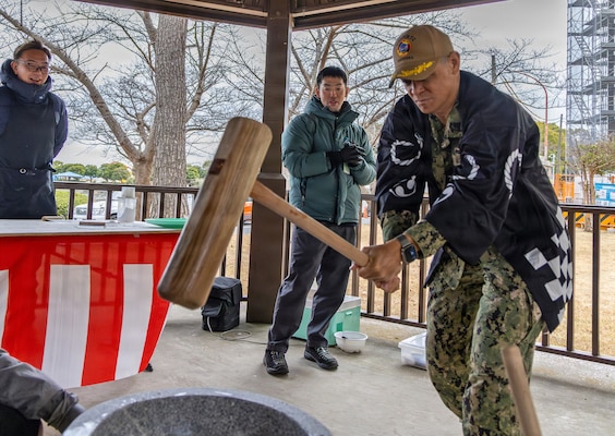 YOKOSUKA, Japan (Jan. 28, 2026) — Capt. Donavon YapShing, deputy director of U.S. Naval Hospital Yokosuka, uses a kine (mallet) to pound rice in an usu (mortar) during a mochitsuki cultural exchange event at the hospital. The Japanese Fellows organized the event to highlight cultural partnership and collaboration between U.S. and Japanese medical professionals. The Japanese Fellowship Program is a yearlong graduate medical education program that has trained Japanese physicians at USNH Yokosuka since 1952. (U.S. Navy photo by Daniel Taylor/USNMRTC Yokosuka Public Affairs)
