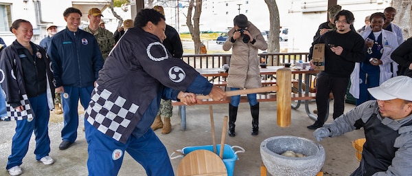 YOKOSUKA, Japan (Jan. 28, 2026) — Personnel assigned to U.S. Naval Hospital Yokosuka take turns using a kine (mallet) to pound rice during a traditional mochitsuki ceremony at the hospital. The Japanese Fellows organized the event to highlight cultural partnership and collaboration between U.S. and Japanese medical professionals. The Japanese Fellowship Program is a yearlong graduate medical education program that has trained Japanese physicians at USNH Yokosuka since 1952. (U.S. Navy photo by Daniel Taylor/USNMRTC Yokosuka Public Affairs)