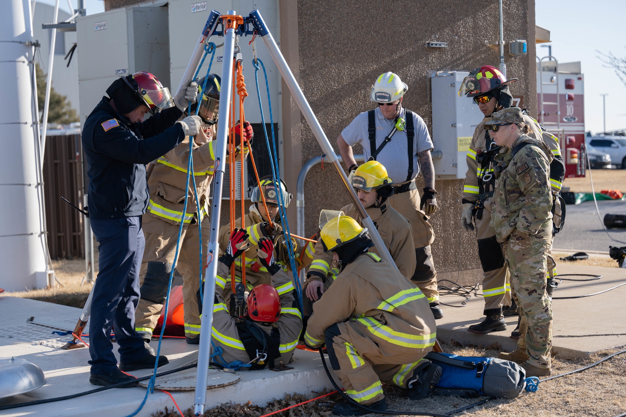 Members of the 97th Civil Engineer Squadron perform a confined space rescue at Altus Air Force Base (AFB), Oklahoma, Jan. 20, 2026. The confined space awareness, operations and technician training allowed the Altus AFB Fire Department to gain awareness of the personal protective equipment they will wear if a confined space rescue is needed. (U.S. Air Force photo by Airman 1st Class Emma Wright)