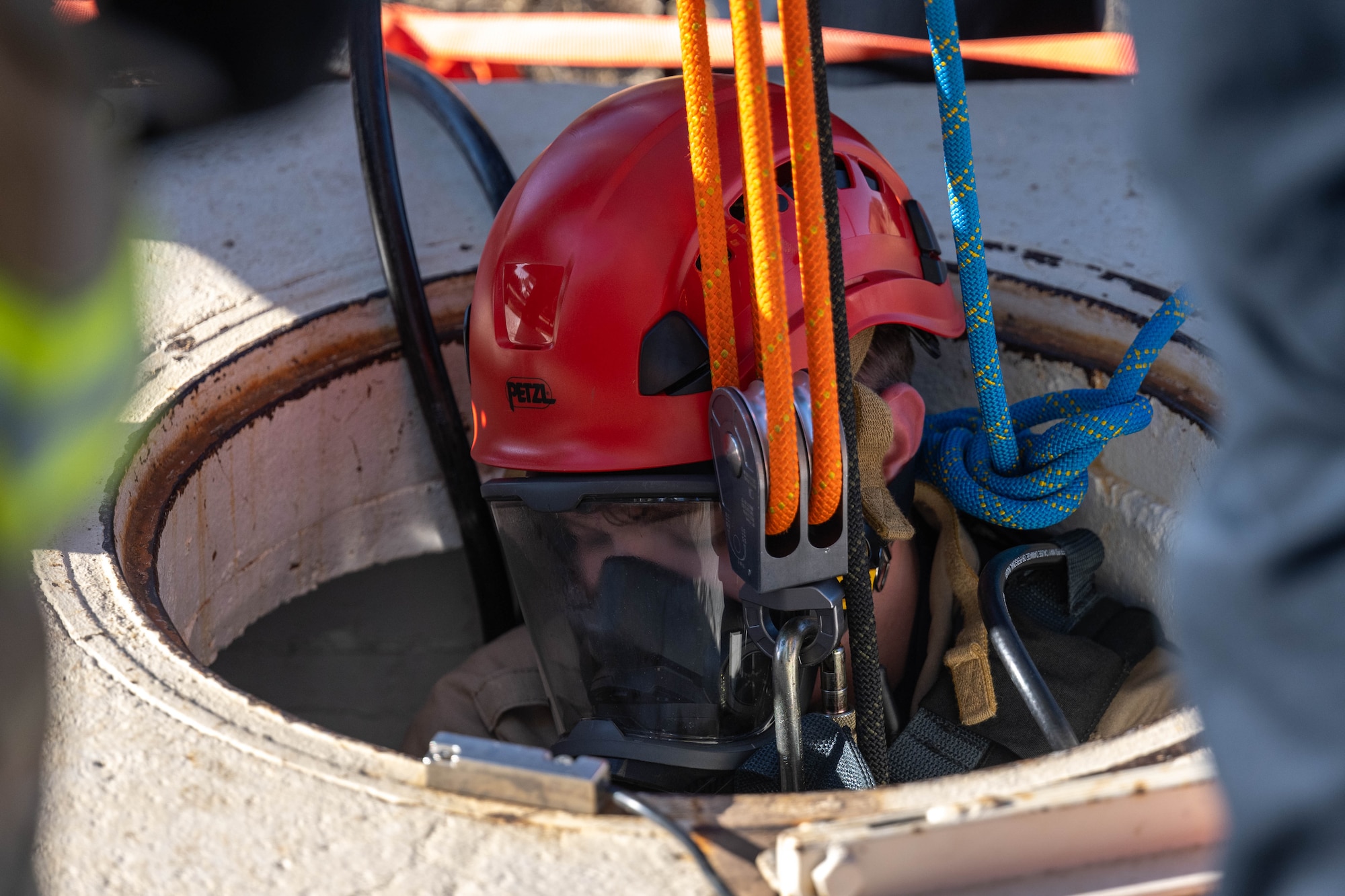 U.S. Air Force Senior Airman James McAlister, 97th Civil Engineer Squadron Fire Department driver operator, enters a confined space at Altus Air Force Base (AFB), Oklahoma, Jan. 21, 2026. The confined space awareness, operations and technician training certified members of Altus AFB Fire Department in confined space response. (U.S. Air Force photo by Airman 1st Class Emma Wright)