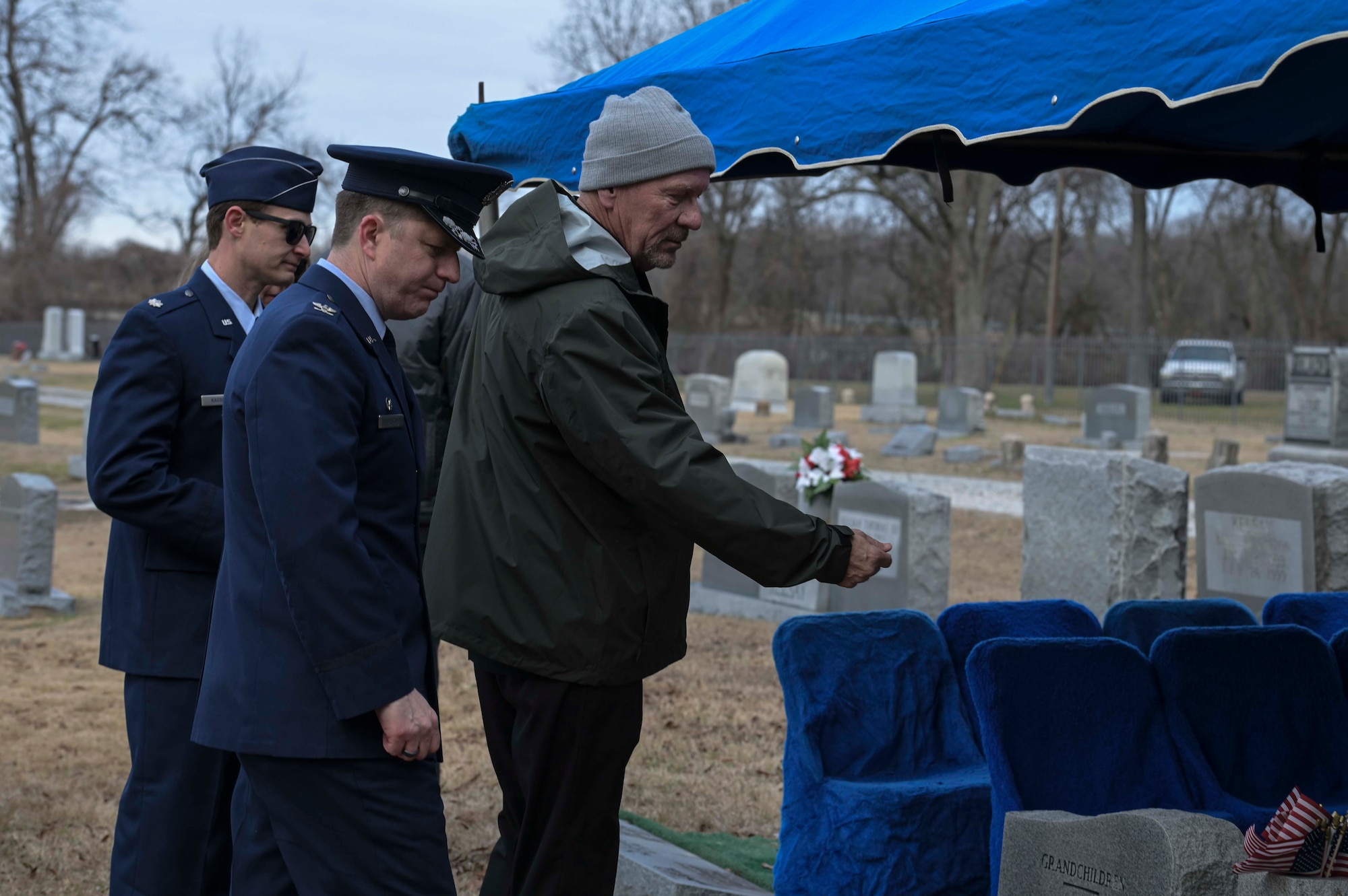 Former fighter pilots toss nickels during a ceremony of life.