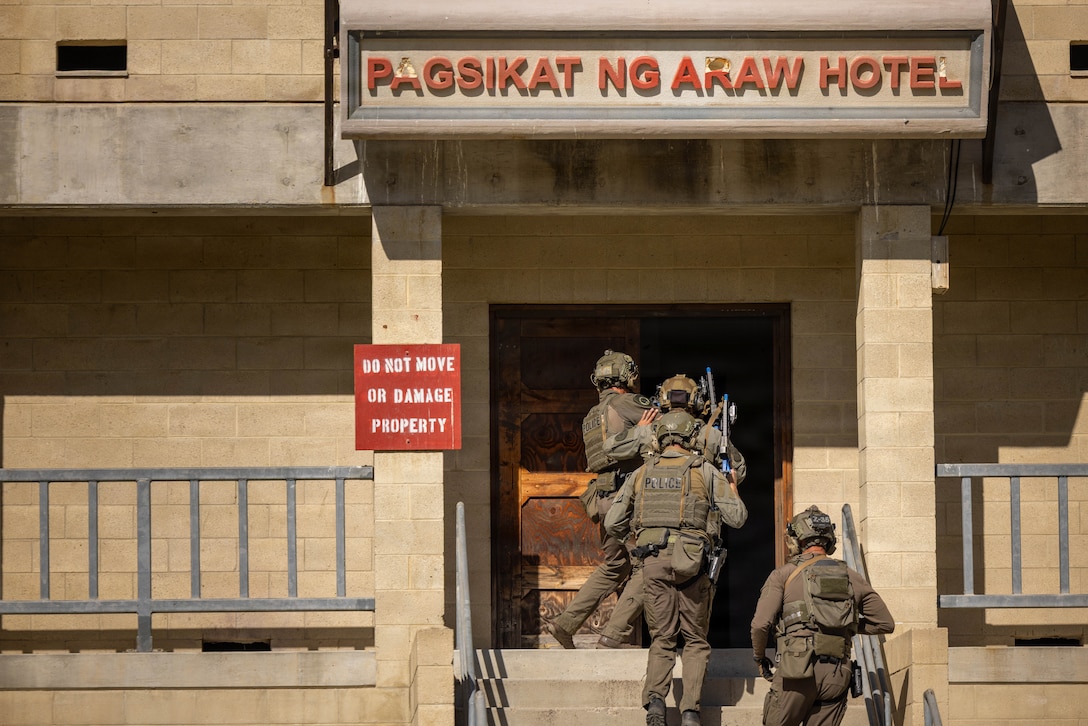 Police officers with the San Diego County Sheriff’s Department Special Weapons and Tactics team participate in an integrated joint training exercise at Marine Corps Base Camp Pendleton, Calif., Jan. 28, 2026. The exercise features U.S. Marines with the Special Reaction Team, police officers with the Escondido Police Department SWAT team, special agents with the United States Secret Service Counter Assault Tactical Team, and the Naval Criminal Investigative Service Regional Enforcement Action Capabilities Team. The training focuses on enhancing interagency coordination by familiarizing participants with each tactical team’s standard operating procedures and conducting practical application drills simulating real-world scenarios to increase overall proficiency among participating agencies. (U.S. Marine Corps photo by Lance Cpl. Adrian Estrada)